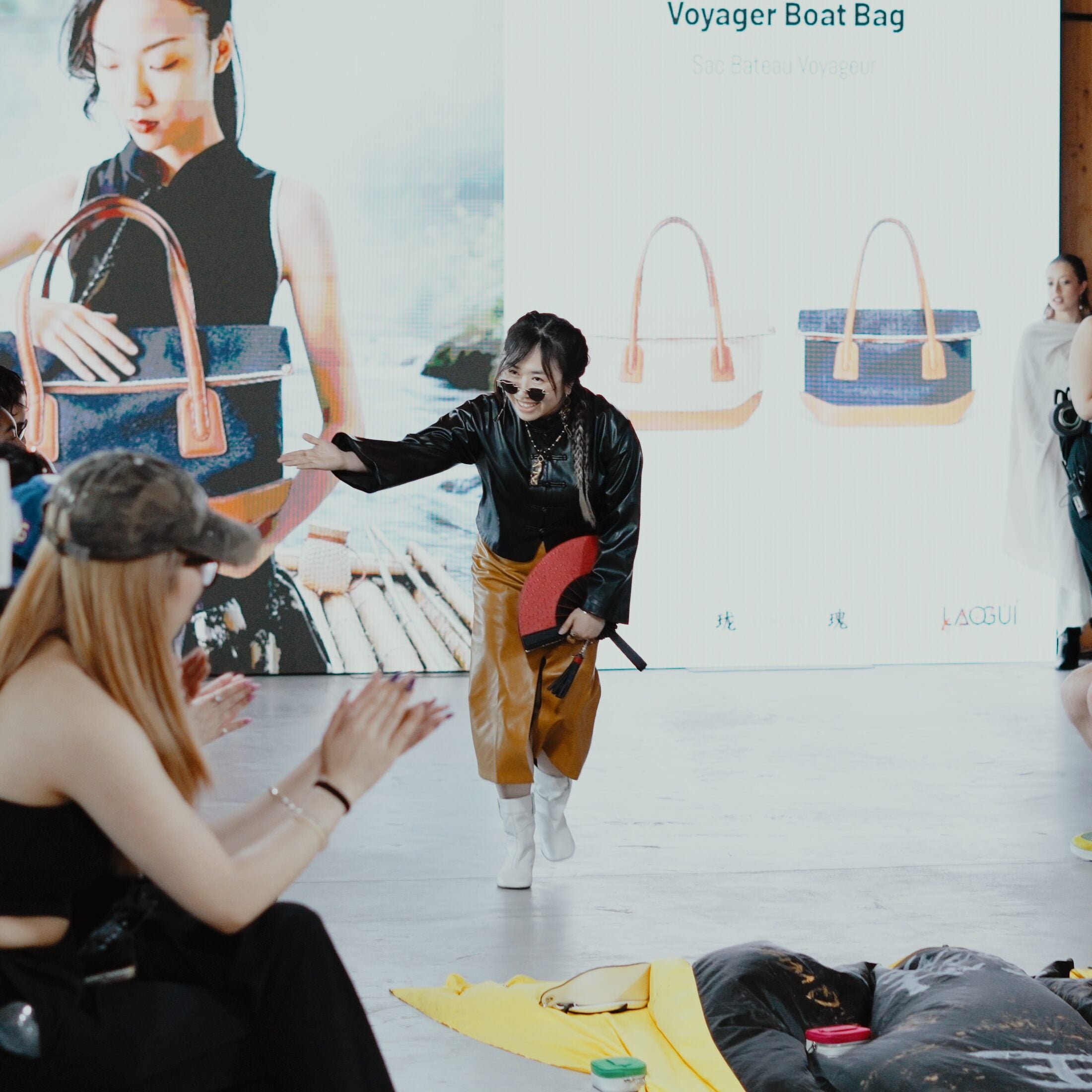 LAOGUI designer runway moment in front of Voyager Boat Bag visuals at Fashion Art Toronto