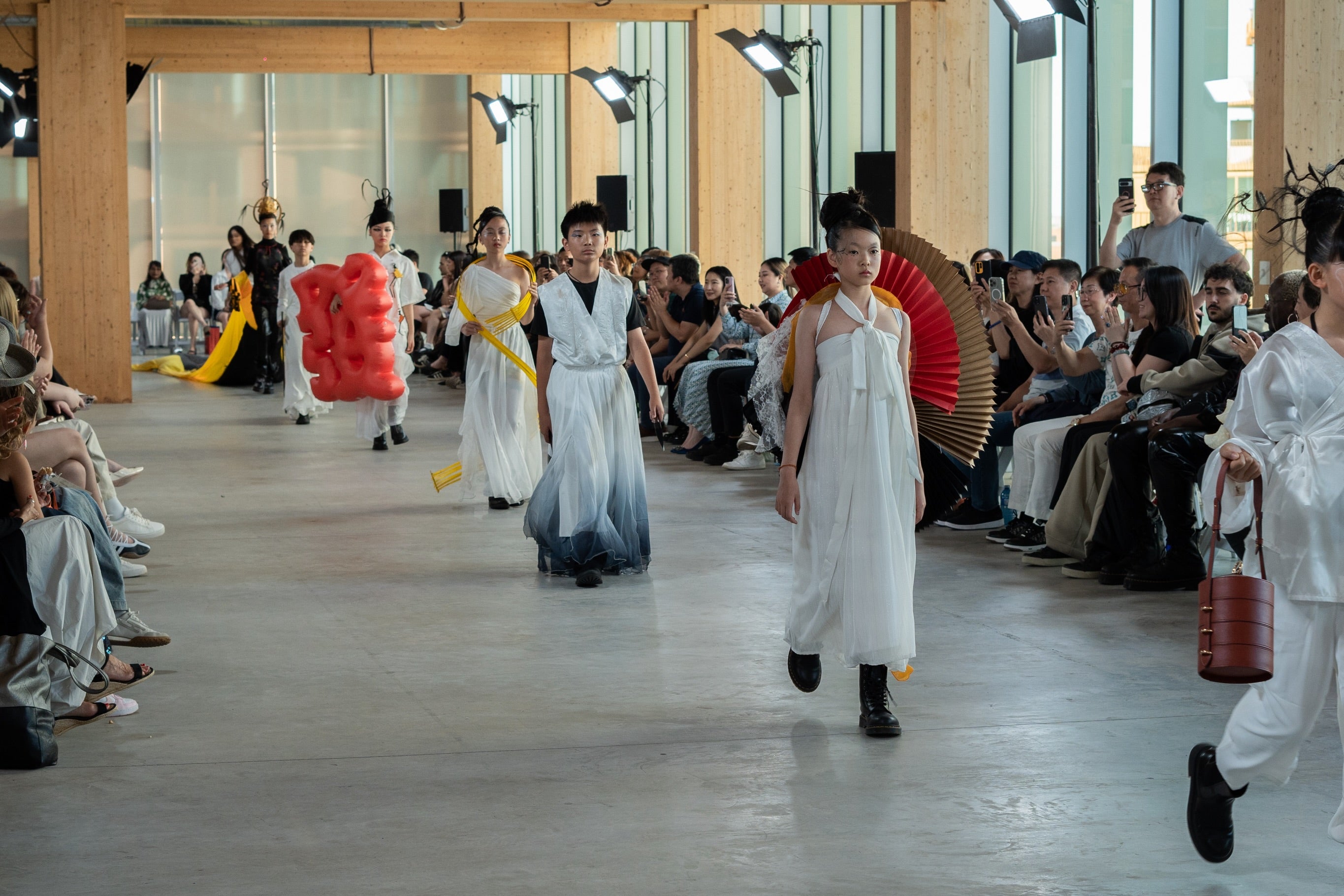 Fashion Art Toronto model carrying LAOGUI red fan bag and bucket-style bag