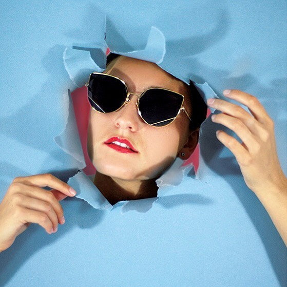 HAZE sunglasses editorial with blue paper backdrop